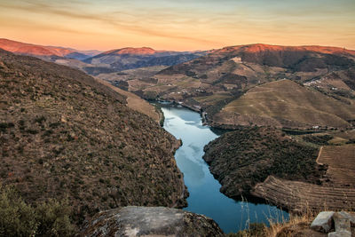 Scenic view of river amidst mountains against sky