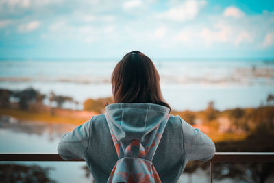 Rear view of woman looking at sunset