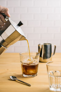 Close-up of wine pouring coffee in glass