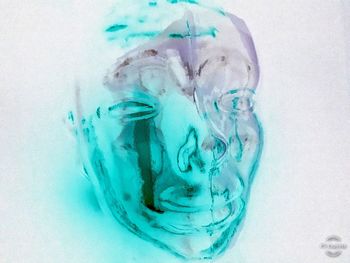 Close-up of ice crystals on glass against sea