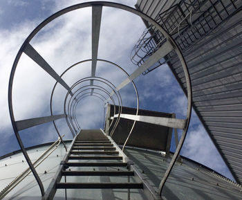 Low angle view of spiral stairs against sky