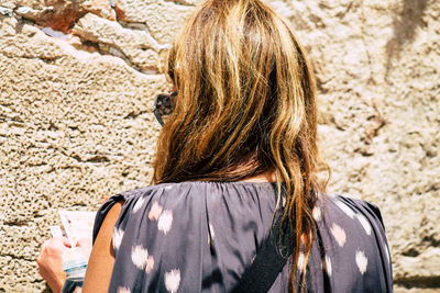 Rear view of woman standing outdoors