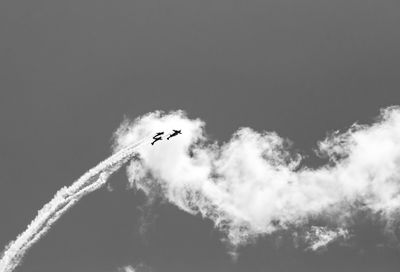 Low angle view of airplane flying in sky