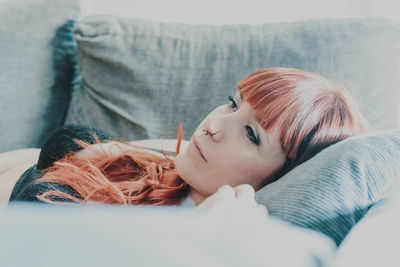 Woman relaxing on sofa at home