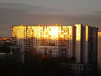 Buildings in city at sunset