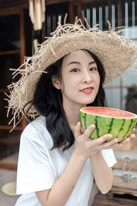 Portrait of young woman wearing hat