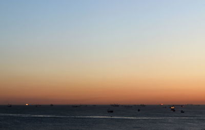 Scenic view of sea against clear sky during sunset