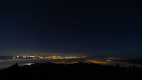 Scenic view of silhouette landscape against sky at night