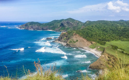 Scenic view of sea and mountains against sky