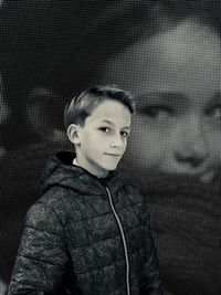 Portrait of boy against photograph