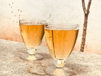 Close-up of drink in glasses against wall