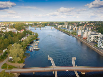 High angle view of townscape by river against sky