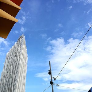 Low angle view of street and buildings against sky