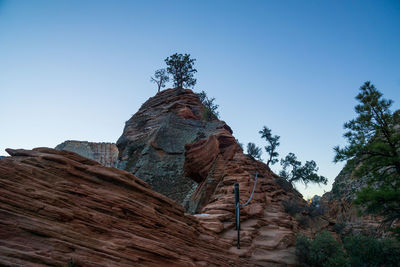 Low angle view of rock formation against clear sky