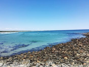 Scenic view of sea against clear blue sky