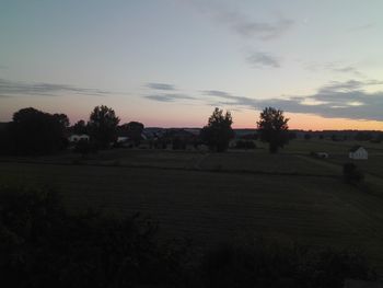 Scenic view of field against sky during sunset