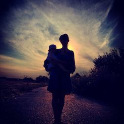 Silhouette of woman at sunset