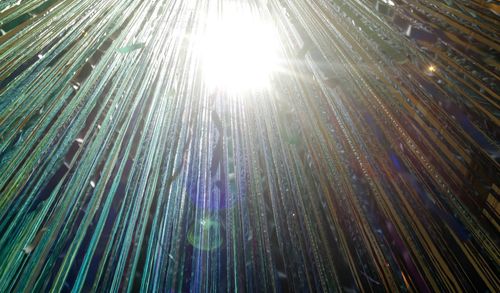 Low angle view of sun shining in sky