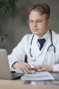 Portrait of doctor examining patient at clinic