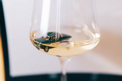 Miniature car in white wine glass