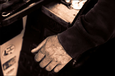 Cropped hand of man at workshop