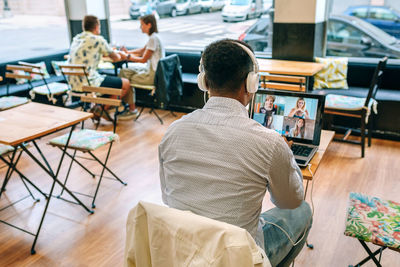 Rear view of man working at home