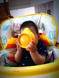 Close-up of boy playing with multi colored ball