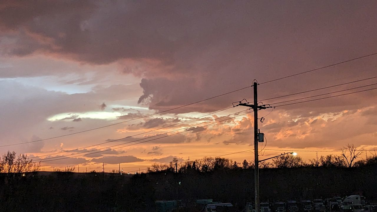 sky, electricity, cable, cloud, electricity pylon, sunset, technology, power supply, power line, nature, evening, beauty in nature, dusk, environment, landscape, power generation, scenics - nature, no people, afterglow, dramatic sky, silhouette, tranquility, tree, outdoors, plant, overhead power line, orange color, land, sunlight, horizon, tranquil scene, architecture, communication, rural scene, storm, red sky at morning, telephone pole