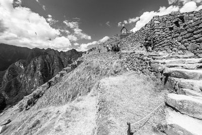 People on mountain against sky