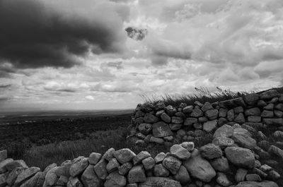Rocks on field against sky
