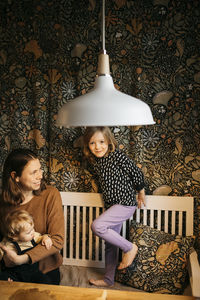 Mother with daughter and son at home