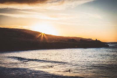 Scenic view of sea against sky during sunset