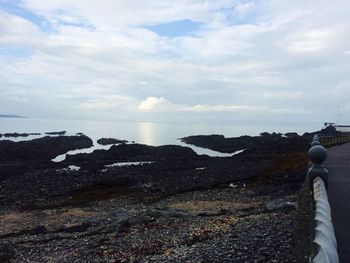 Scenic view of sea against cloudy sky