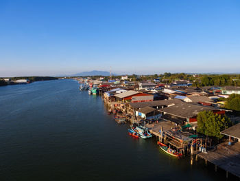 High angle view of townscape by sea against clear sky