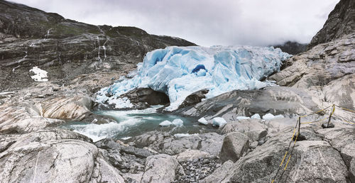 Scenic view of frozen lake against rocks