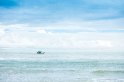 Sailboat in sea against sky