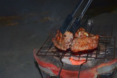 High angle view of meat on barbecue grill