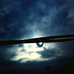 Low angle view of silhouette water drop against sky