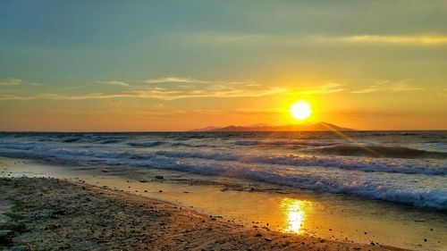 Scenic view of beach against sky during sunset