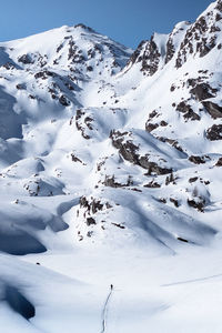 Scenic view of snow covered mountains against sky