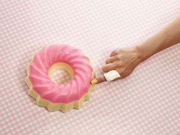 Close-up of hand holding cake