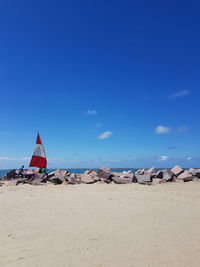 Scenic view of beach against blue sky