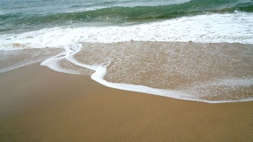 High angle view of surf on beach