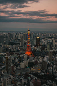 Aerial view of illuminated city buildings during sunset