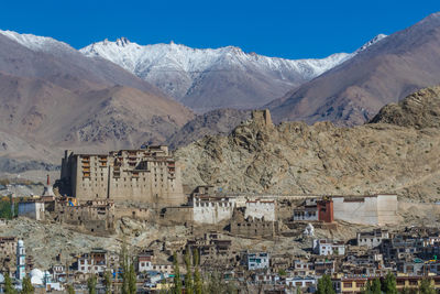 Buildings in town against mountain range