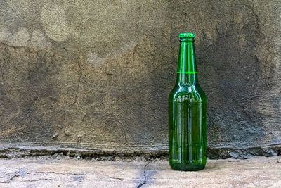 High angle view of empty bottle against wall