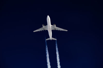 Low angle view of airplane flying against clear sky