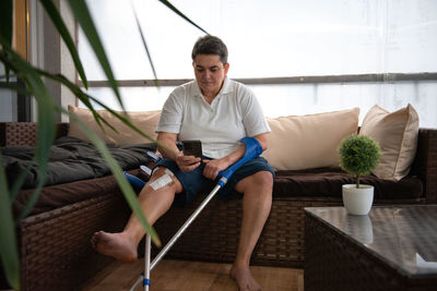 Portrait of man sitting on sofa at home
