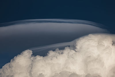 Airplane flying over cloudscape against sky