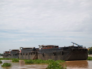 Boats moored in sea against sky